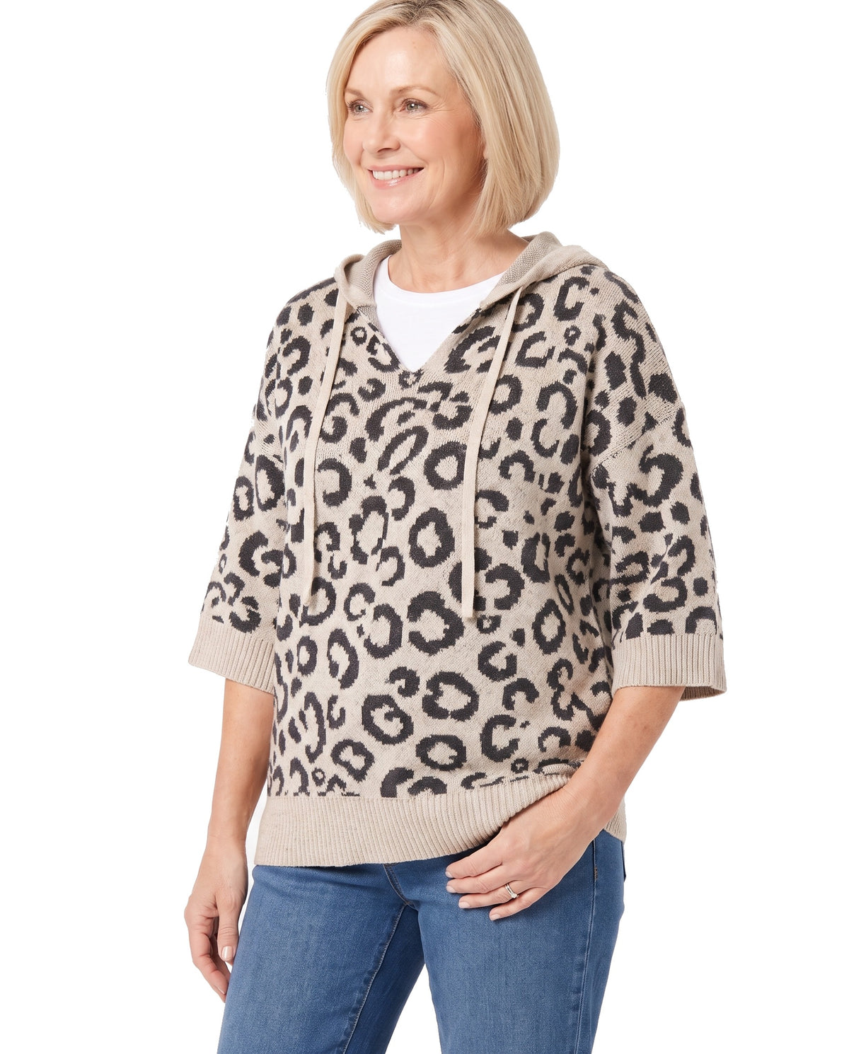 Three quarter view of the khaki leopard hooded knit sweater worn with jeans