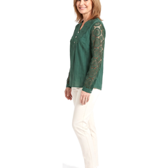 Three quarter view of the same woman in the green crochet lace blouse