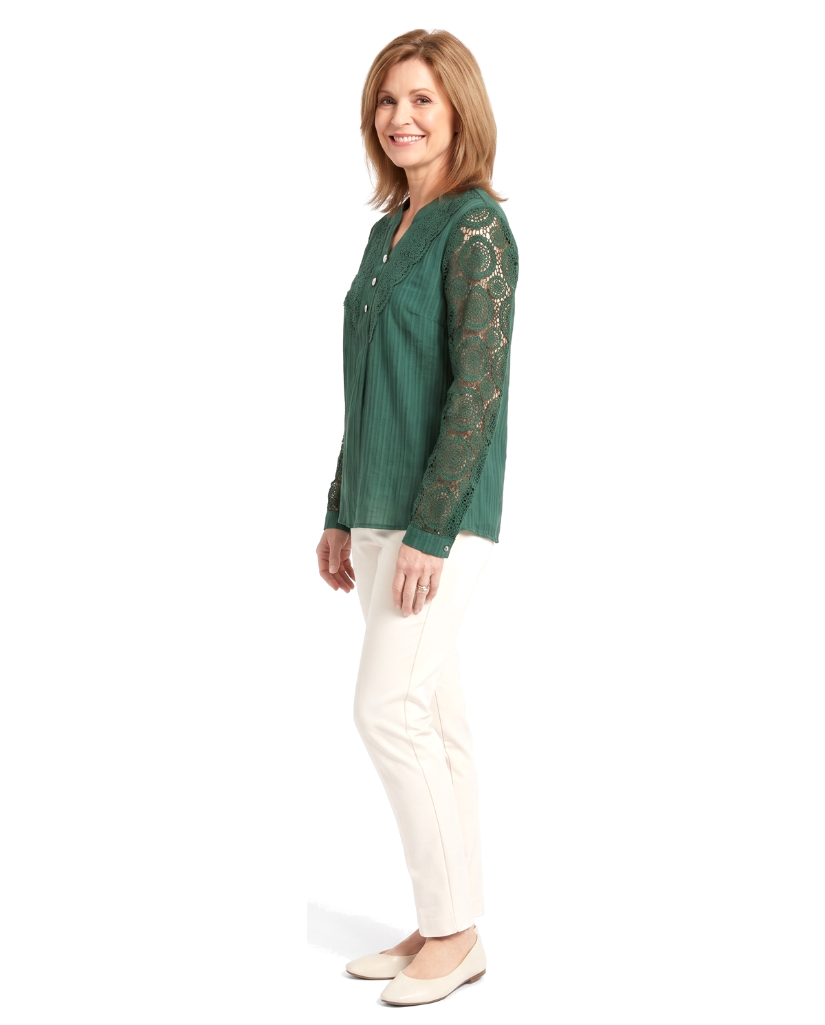 Three quarter view of the same woman in the green crochet lace blouse