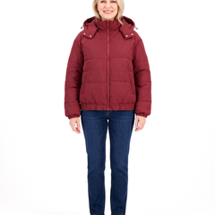 Woman wearing the wine red hooded puffer jacket with jeans, front view