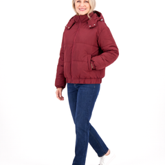 Woman walking in the wine red hooded puffer jacket, three-quarter view