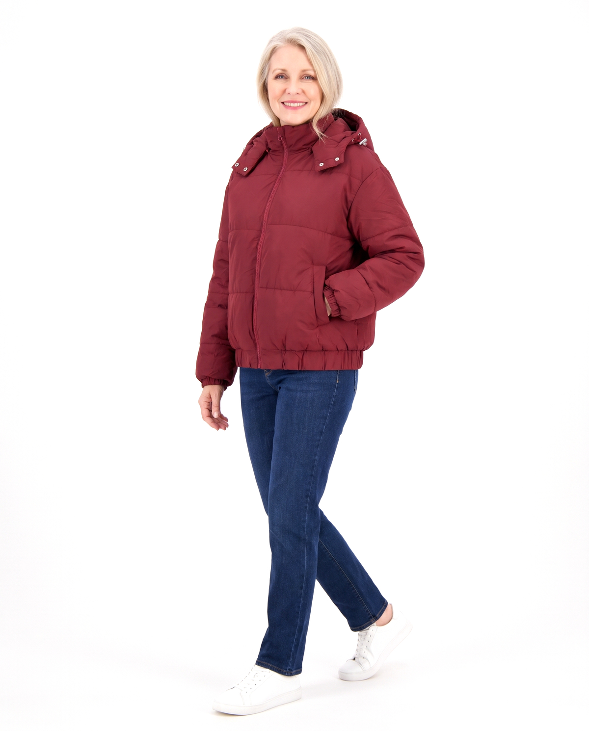 Woman walking in the wine red hooded puffer jacket, three-quarter view