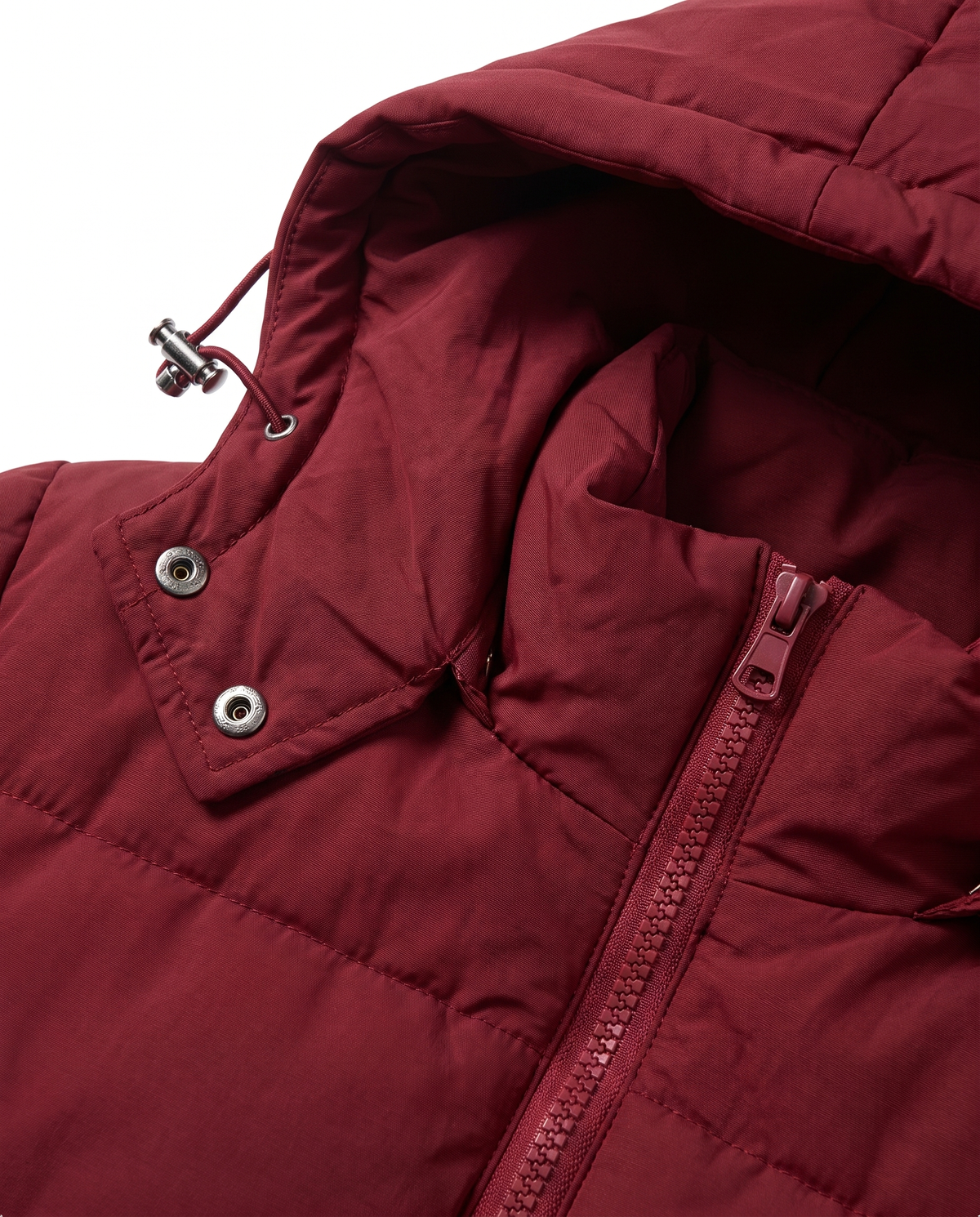 Close-up of the snap-off hood, drawcord toggle and front zip