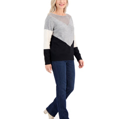 Woman walking in the black color block boat neck sweater, three-quarter view