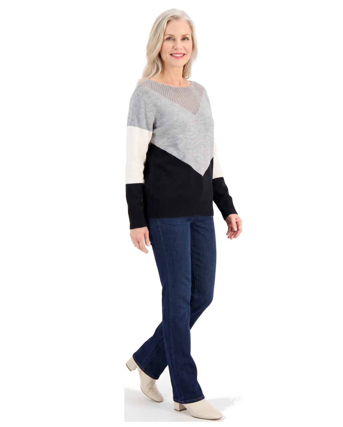 Woman walking in the black color block boat neck sweater, three-quarter view
