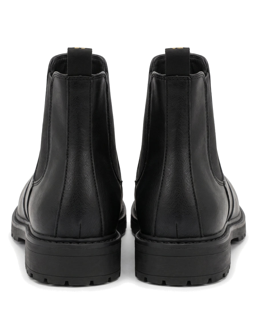Women's black lug sole Chelsea boots, back view