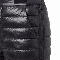 Close up detail of the glossy black quilted channels, velcro waist tab and full length side zip on the Aurora snow pants