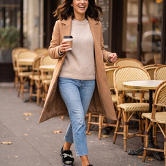 Woman walking past a cafe terrace with coffee in black crystal bow platform loafers