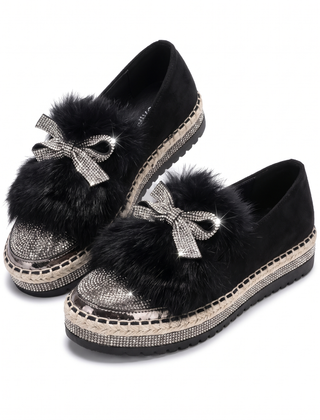 Black crystal bow platform loafers with faux fur trim, pair shown on white
