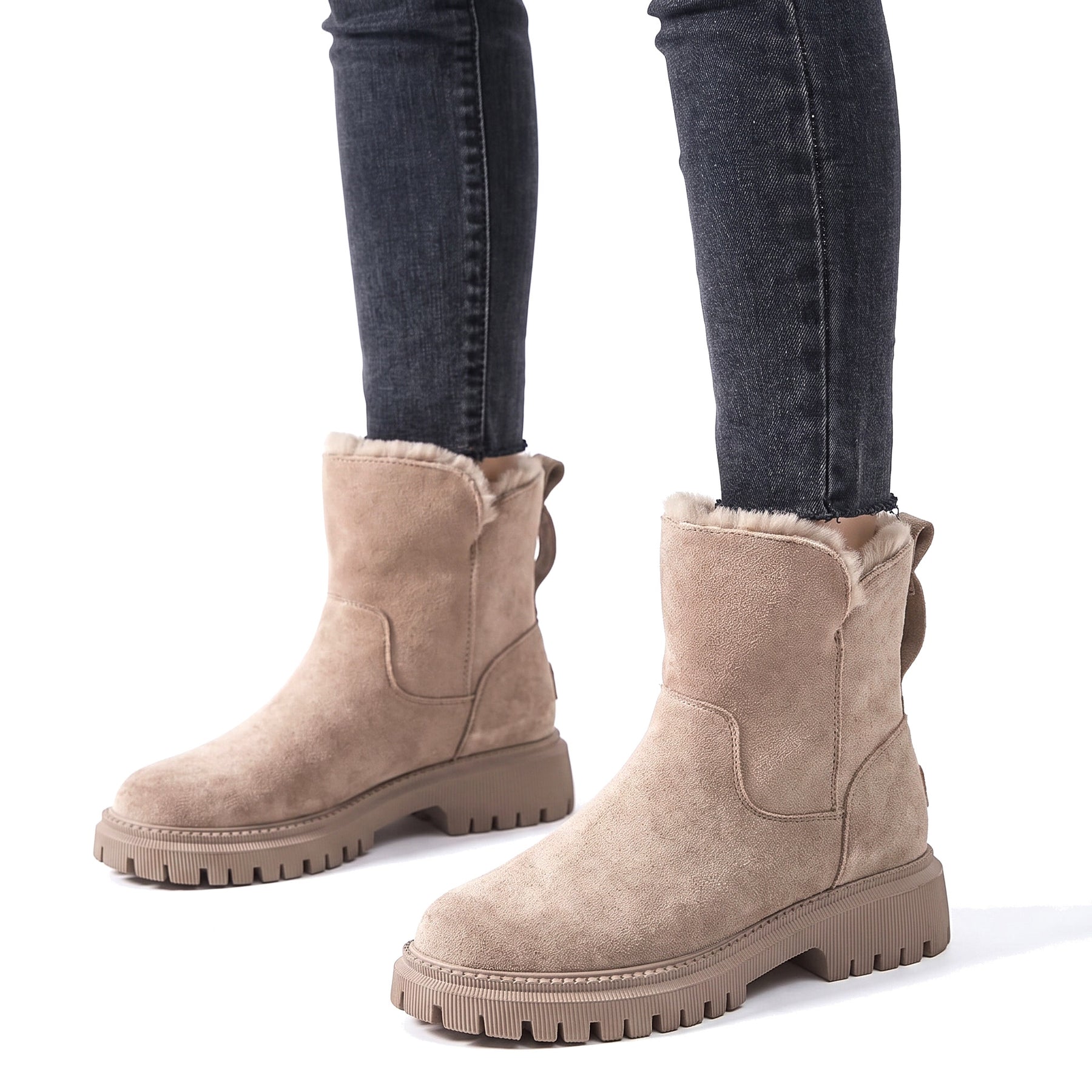 Valerie Women's Fleece-Lined Suede Ankle Boots in beige worn with slim jeans on a white background