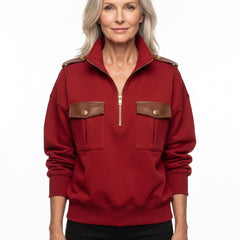 Woman wearing red military-style pullover with PU leather trim