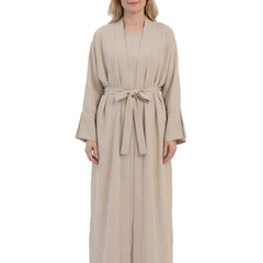 Woman wearing beige open front cardigan and dress set