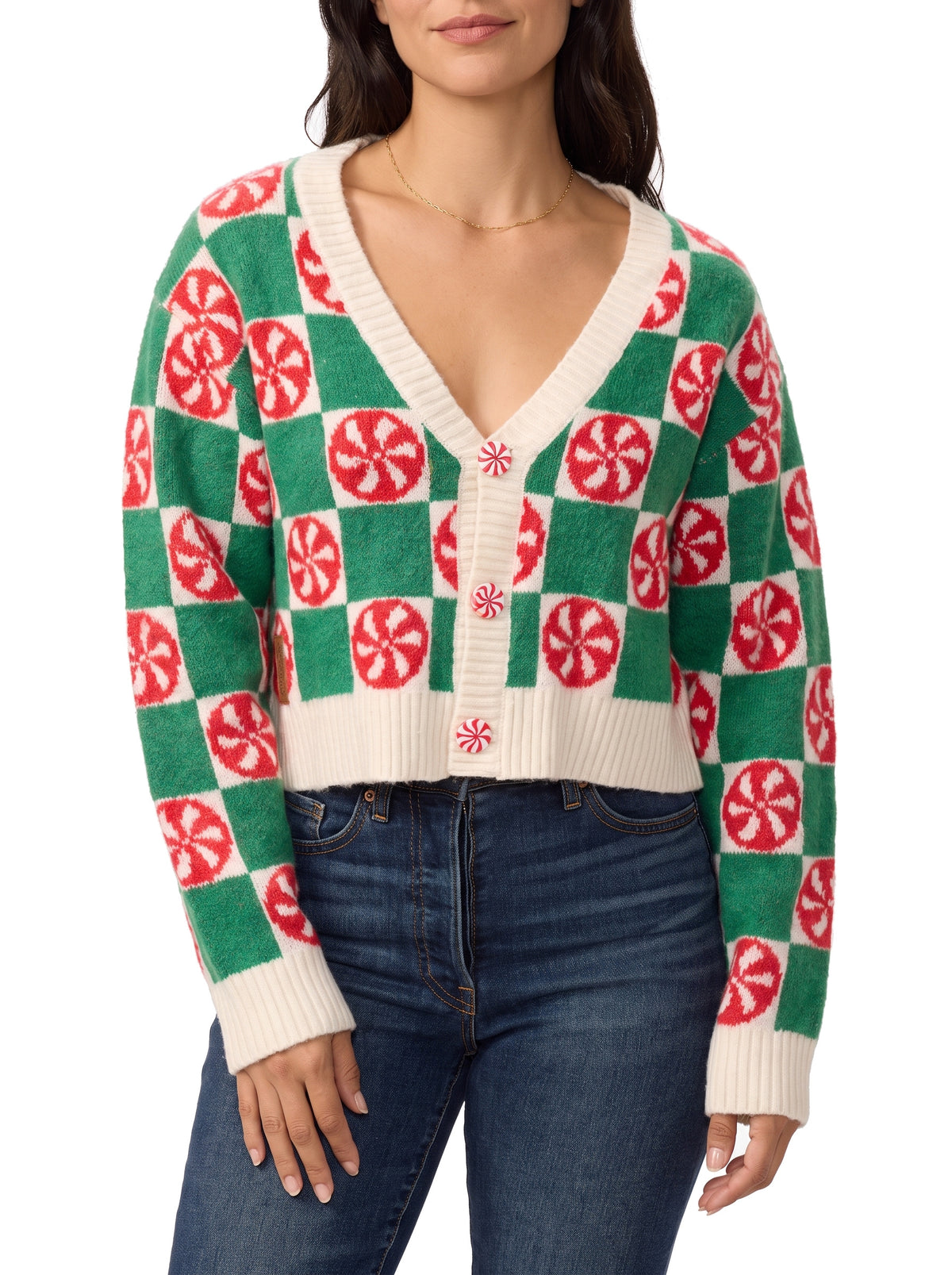 Woman wearing green and cream checkered cropped cardigan with red peppermint candy motifs